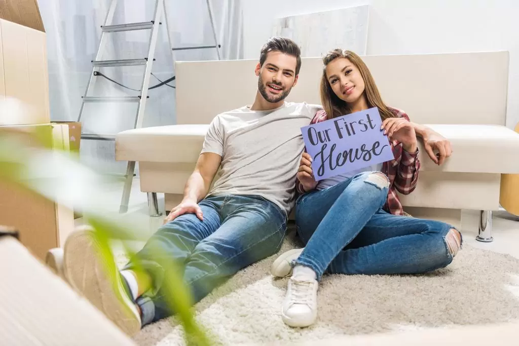 Stock Photo Couple With Our First House Sign